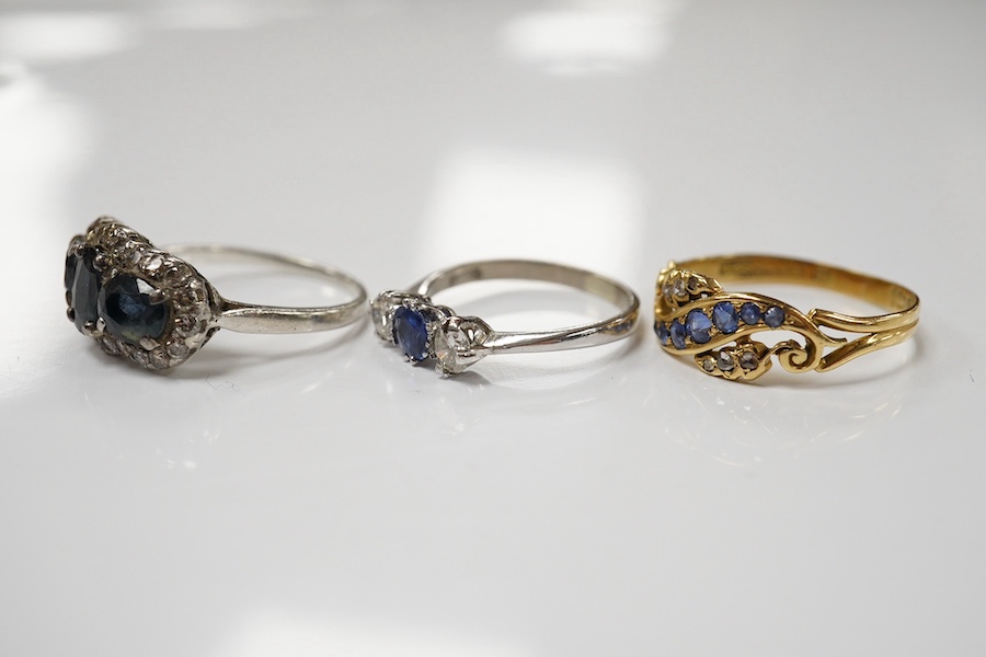 An 18ct white metal, sapphire and diamond set three stone ring, size L and two other sapphire and diamond rings, one late Victorian, gross weight 8.5 grams. Condition - fair to good